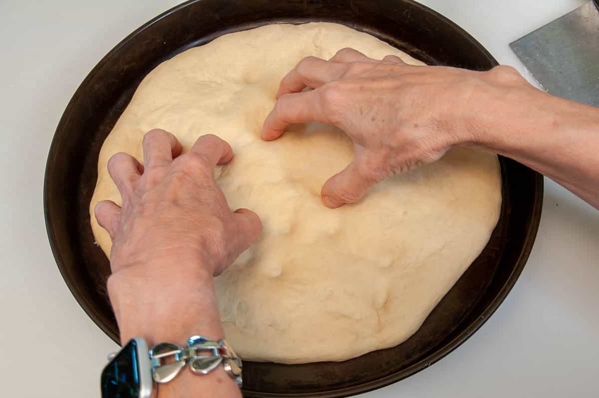 dimpling the dough with fingertips