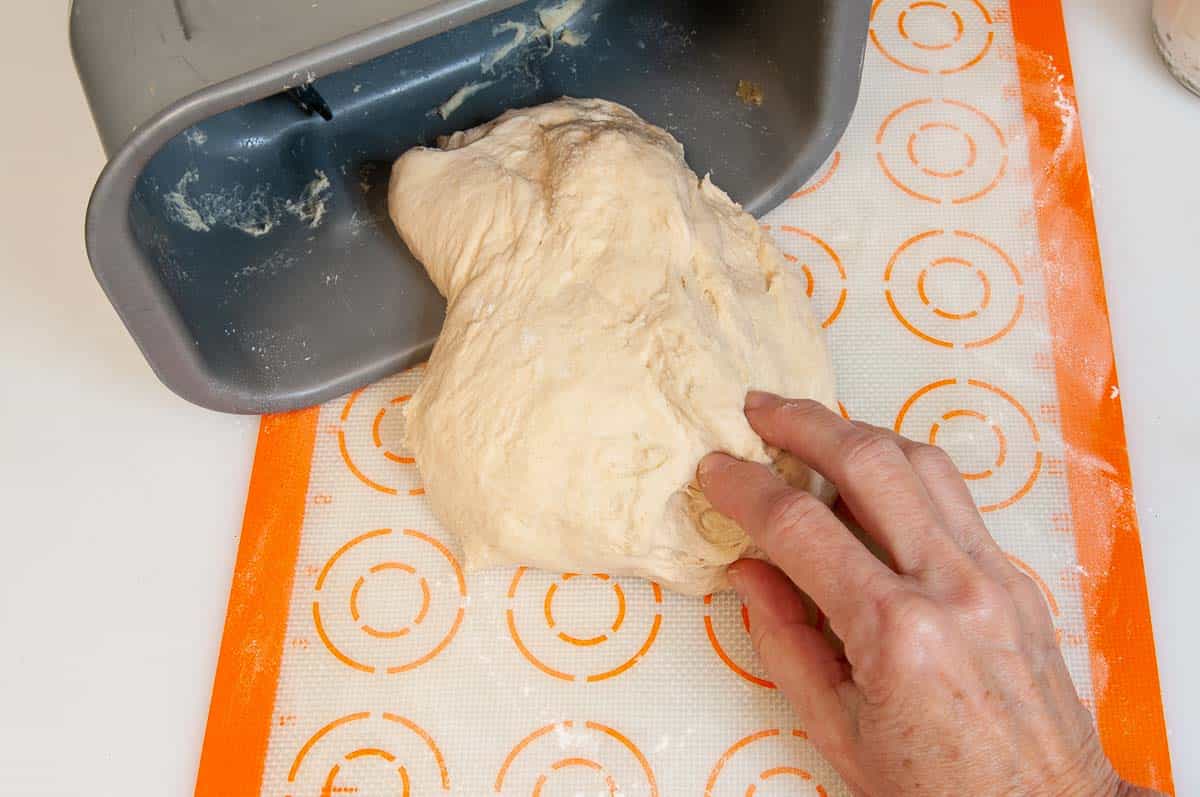 removing dough from the bread machine pan.