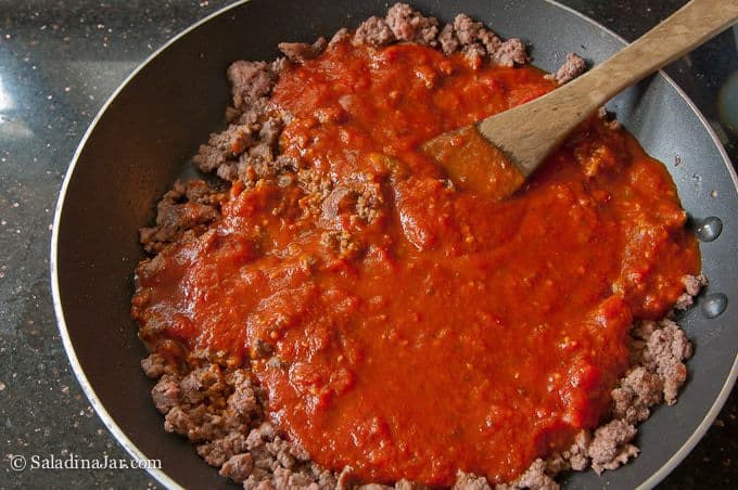 spaghetti and sauce in a skillet
