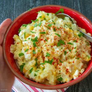 Potato salad garnished with paprika and parsley