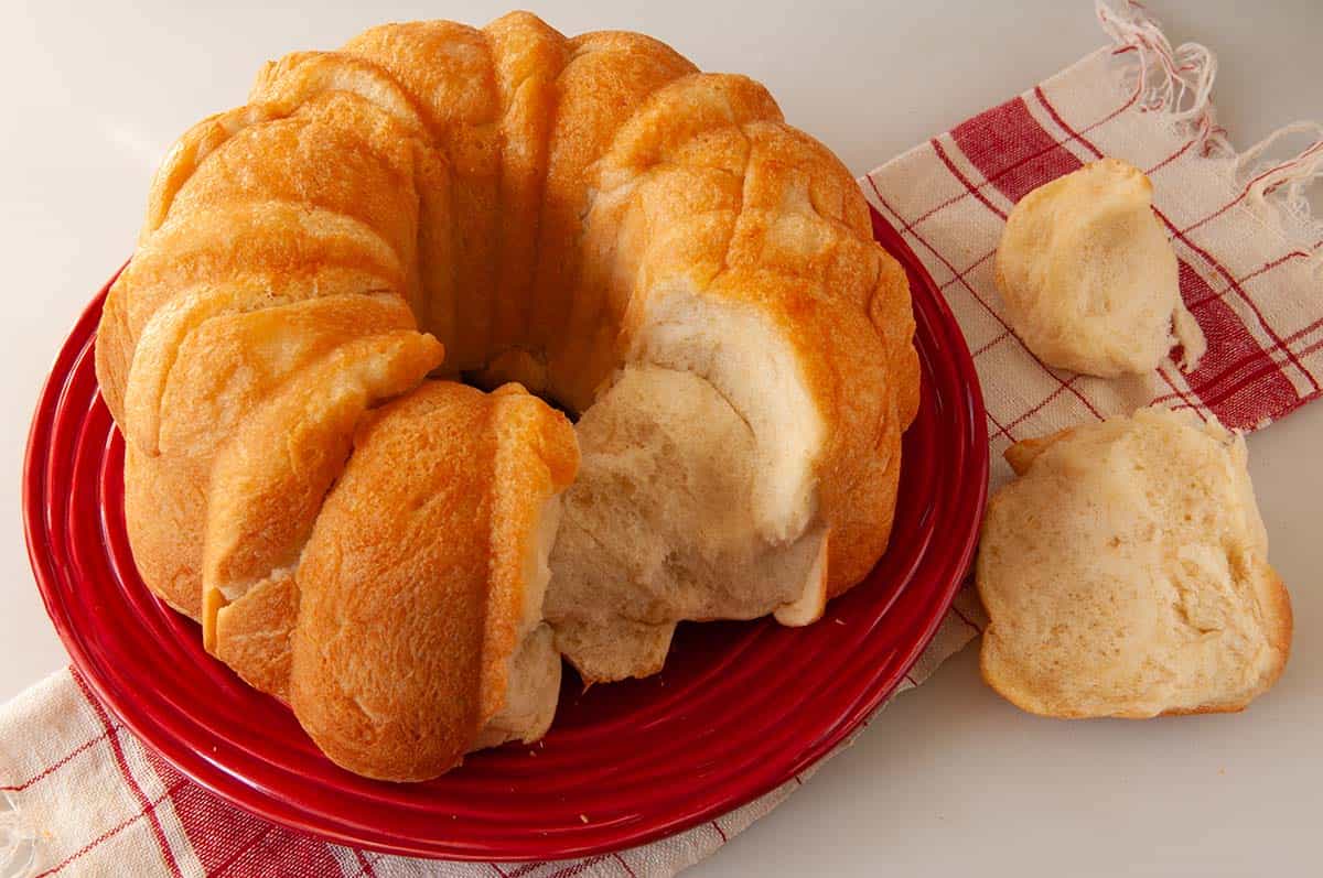 Monkey bread with pieces torn off to show the internal texture.