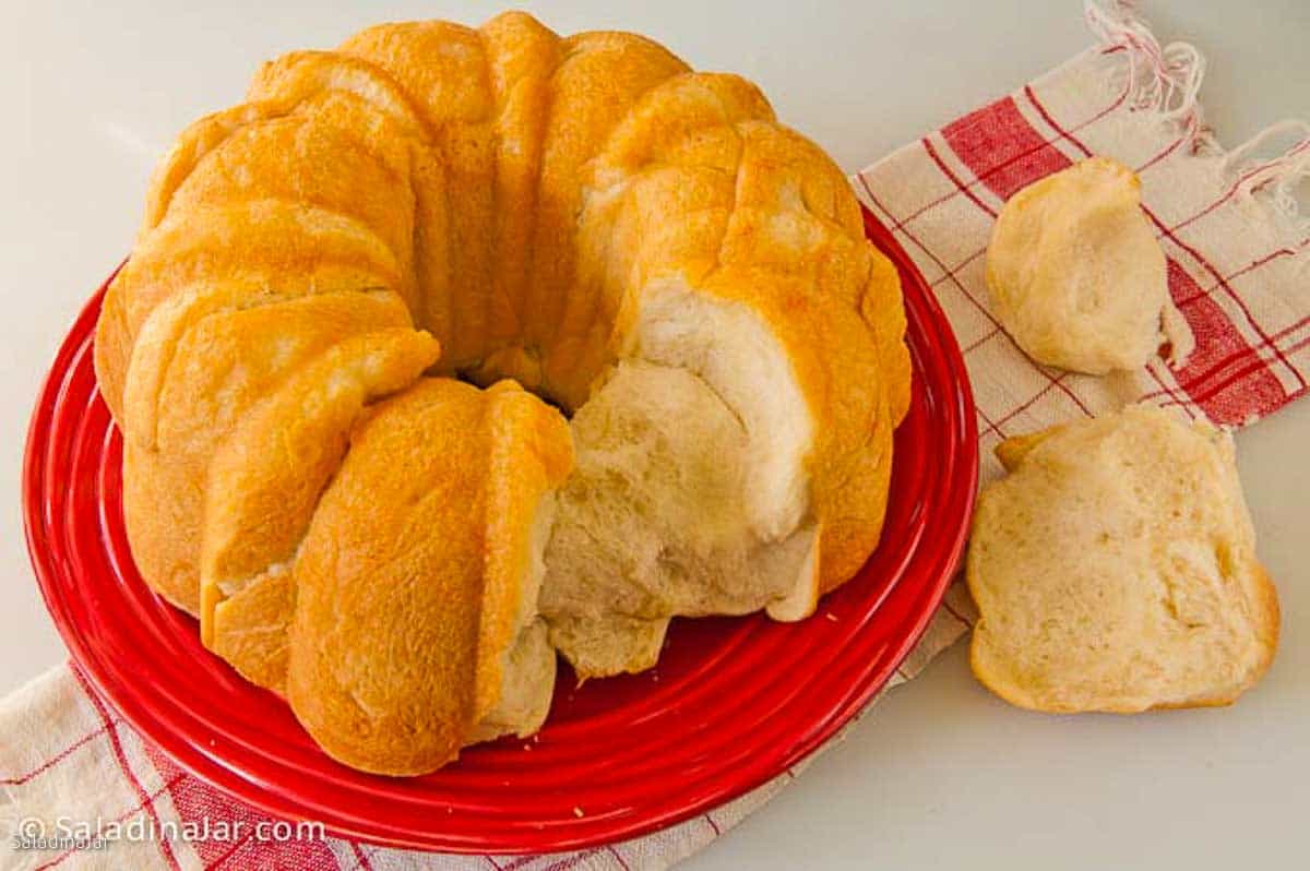 savory monkey bread with a couple of pieces broken of to show the interior texture.