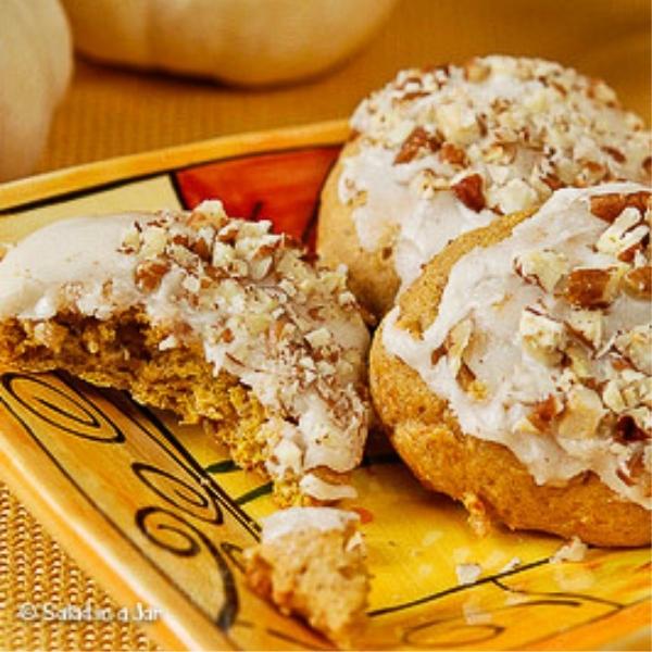 Iced pumpkin cookies on a plate