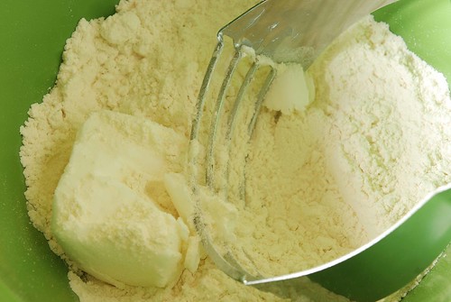 Using a fork to cut fat into flour.