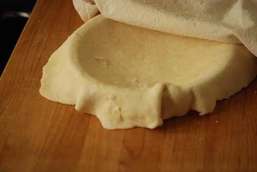 showing the dough flipped into the pie plate