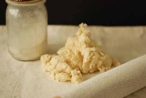 dumping the crumbly dough onto a floured cloth