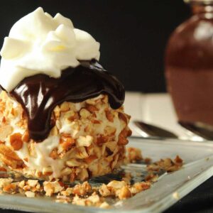 ICE CREAM BALLS rolled in pecans WITH HOT FUDGE SAUCE on top