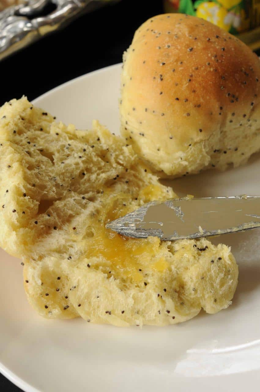 Poppy Seed Rolls split open with lemon curd on the side.