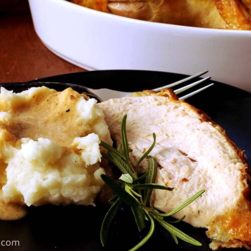 rosemary chicken alongside mashed potatoes and instant gravy.