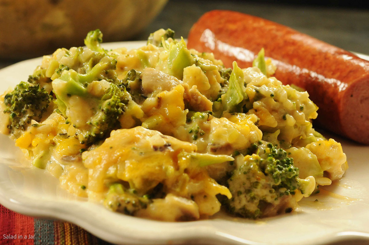 broccoli cheese and rice casserole on a plate with sausage