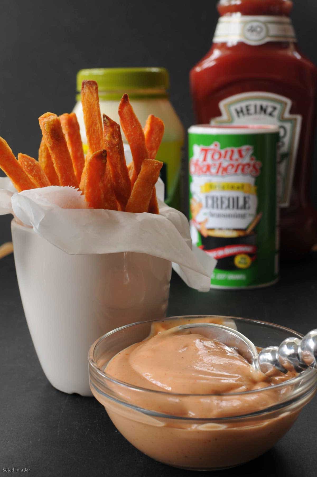 cajun dipping sauce shown with sweet potato fries and other ingredients