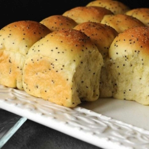 poppy seed rolls on a white serving dish