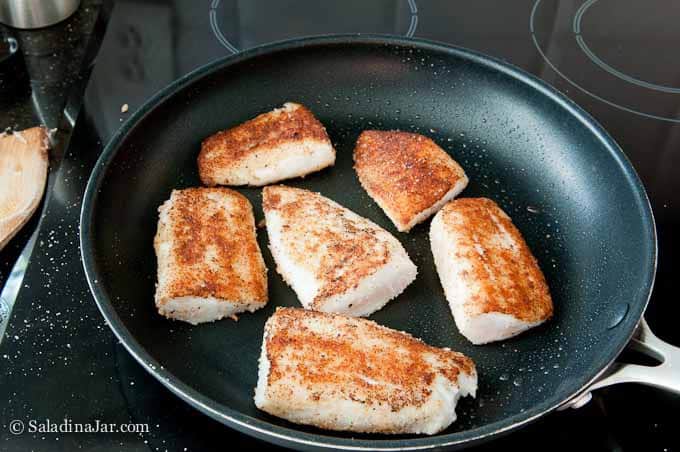 frying the tilapia with bread crumbs.