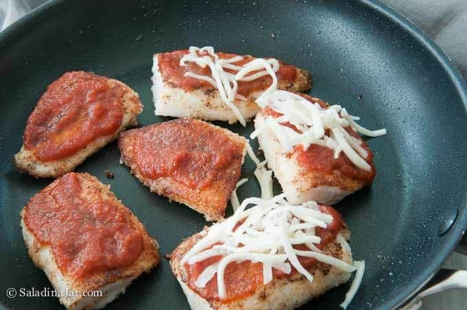 pizza sauce on top of fish, then cheese
