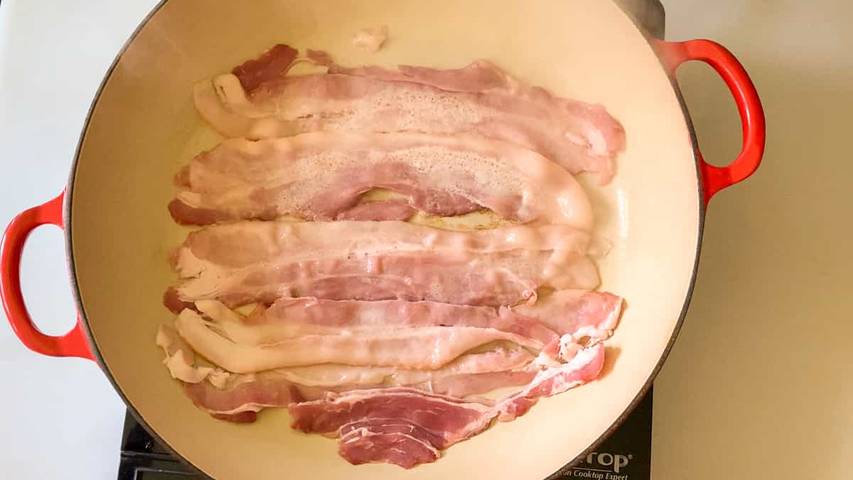 cooking the bacon in a large skillet