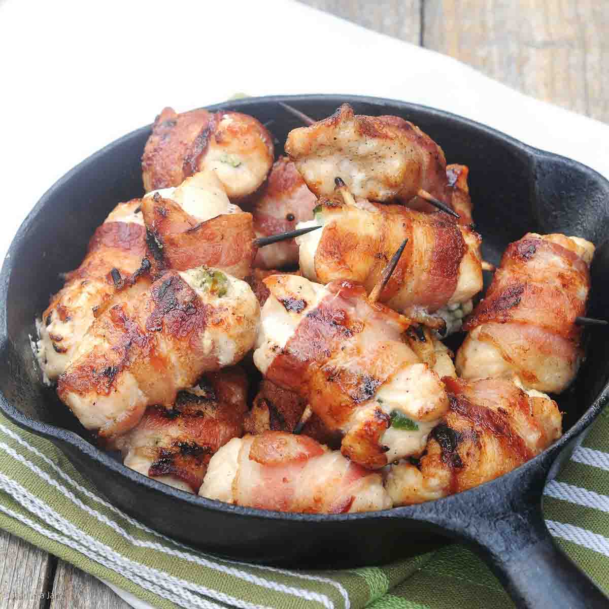 BACON-WRAPPED CREAM CHEESE CHICKEN BITES in an iron skillet
