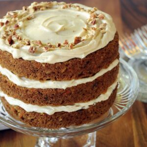Uncut Carrot layer cake without pineapple on a pedestal dish.