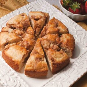 coffee cake made with Bisquick is sliced ready to serve on a plate.