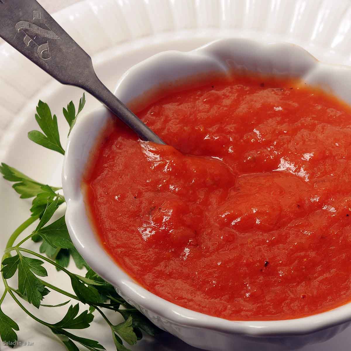 tomato gravy in a bowl with spoon.