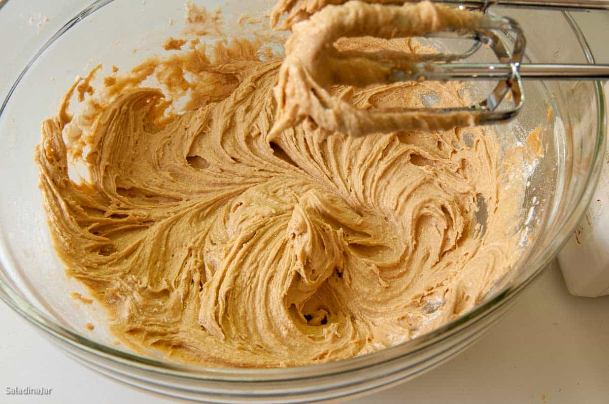 stirring the dough to barely mix in the flour