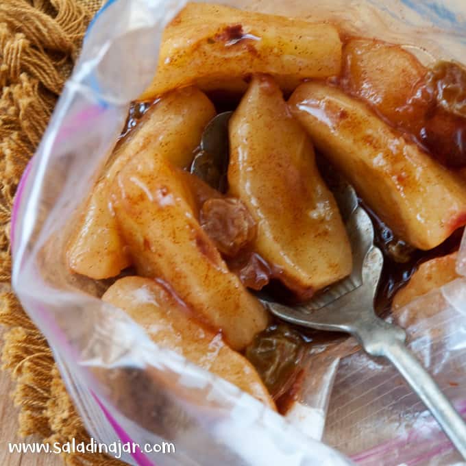 Apples in a Bag with a spoon.