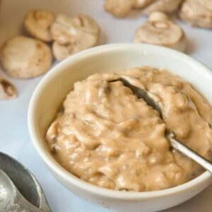 HOMEMADE CONDENSED CREAM OF MUSHROOM SOUP in a white bowl with spoon