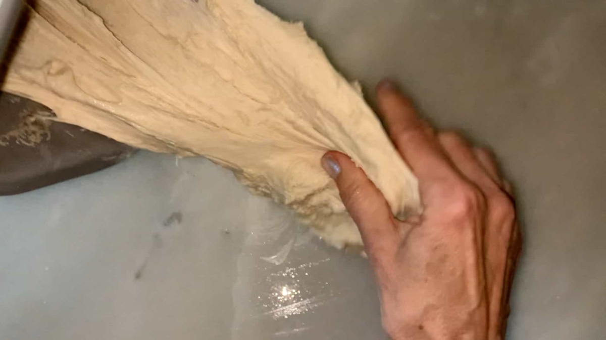 pulling dough out of the bread machine