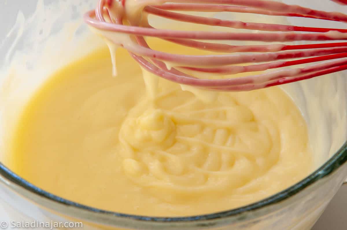 pastry cream dripping off the whisk shows how thick it is.