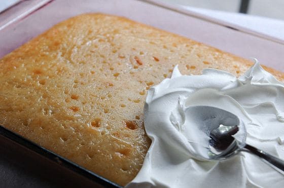 Amie's Triple Coconut Cake--spreading topping on cake