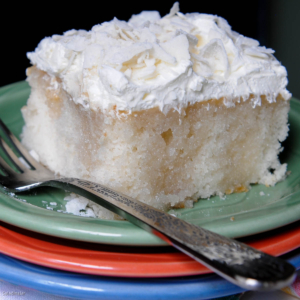 piece of coconut cake on a pile of plates