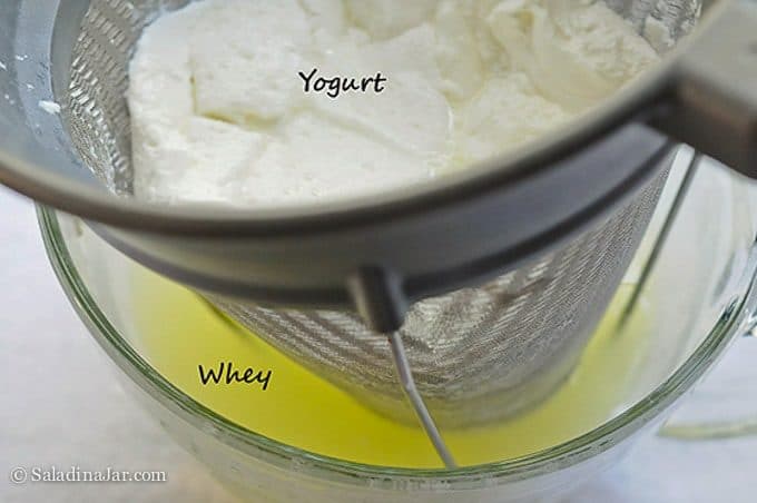 straining whey from yogurt using a fine bouillon strainer