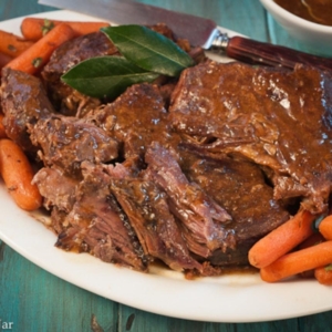 simple pot roast with carrots on a platter