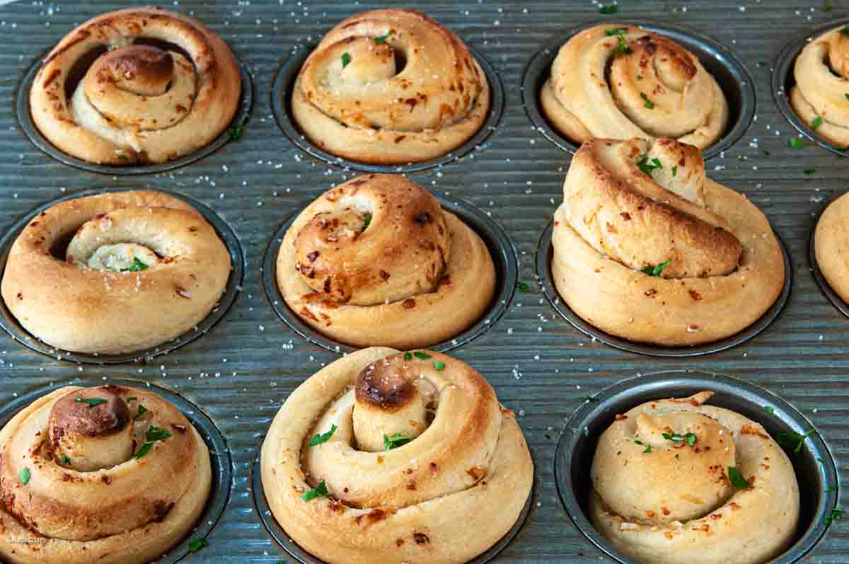 Baked rolls garnished with parsley.