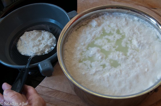 separating the curds using a slotted spoon and fine-mesh strainer