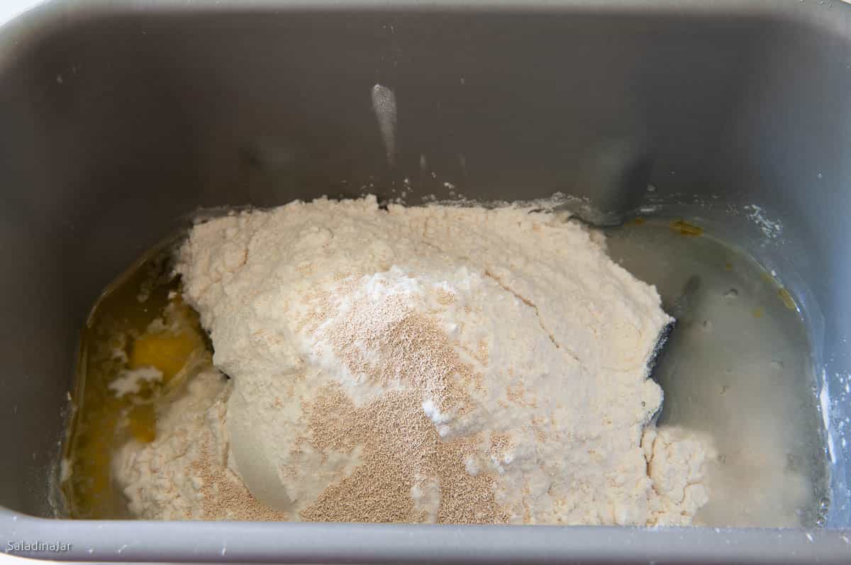 all ingredients added to the bread machine pan except for glaze ingredients