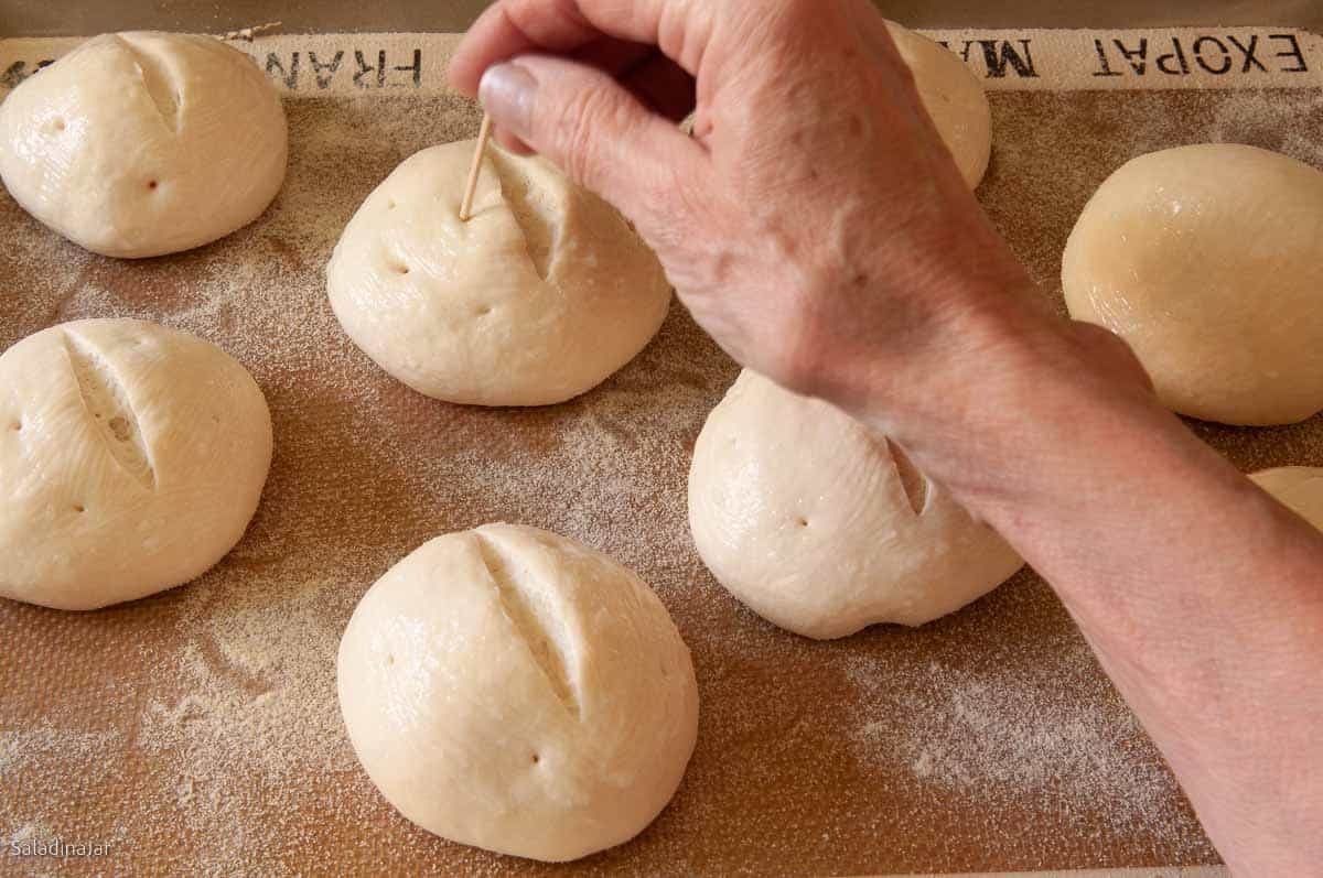 poking rolls with a toothpick.