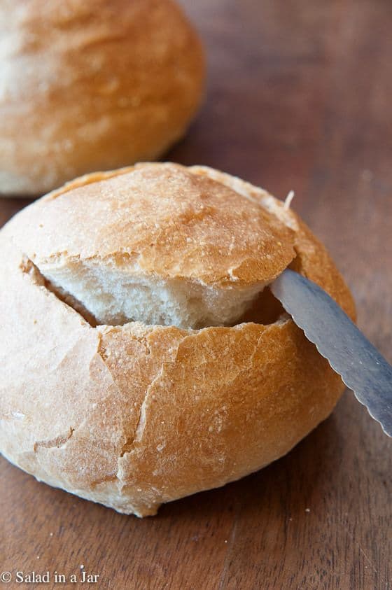 Carving a hole in a crusty roll for the soup