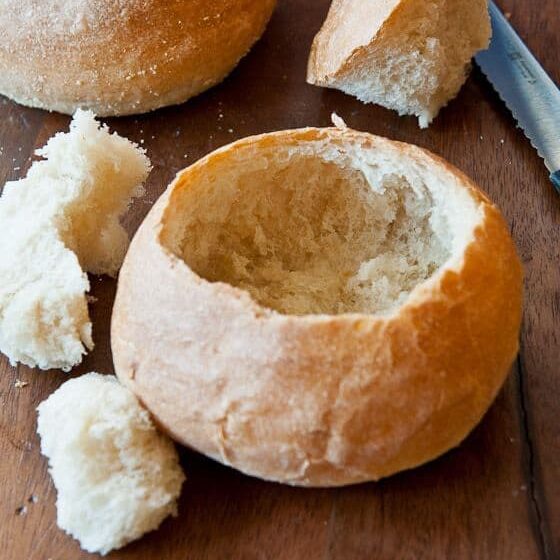 Pulling bread out of the middle of the roll to make a "soup bowl."
