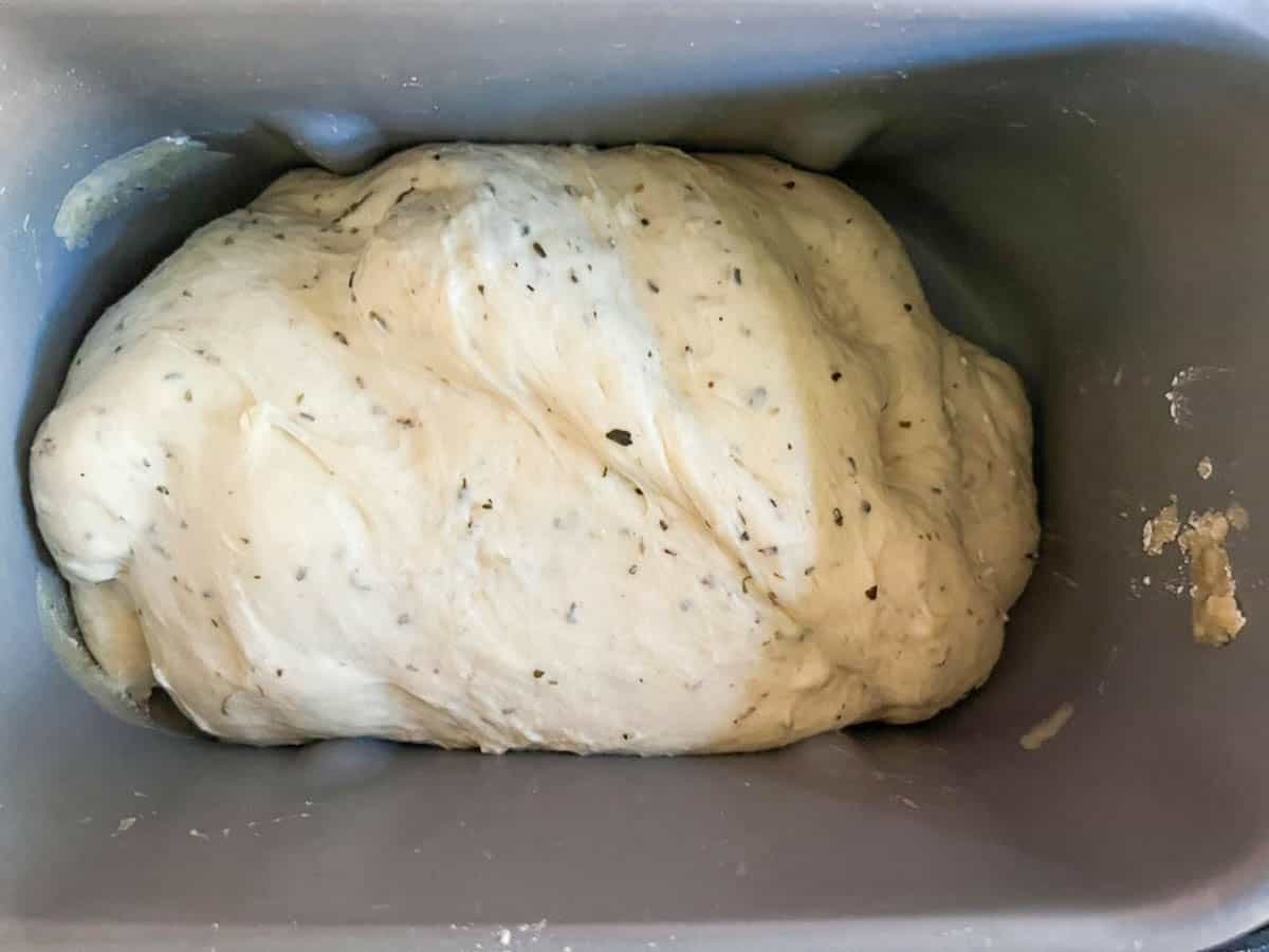 Dough with herbs in a bread machine.