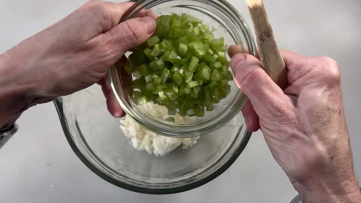 Oil, onion, and chopped celery in a microwave-safe batter bowl.