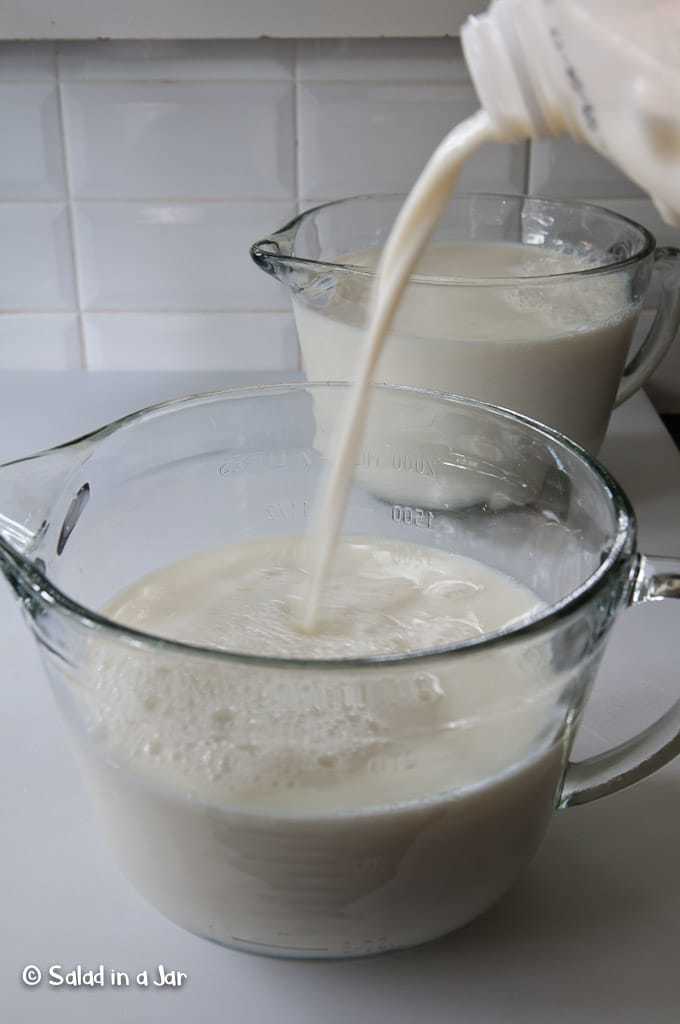 pouring milk into microwave-safe container.