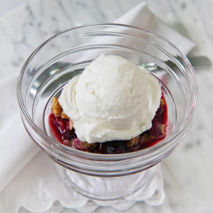 A bowl of skyr over berry cobbler