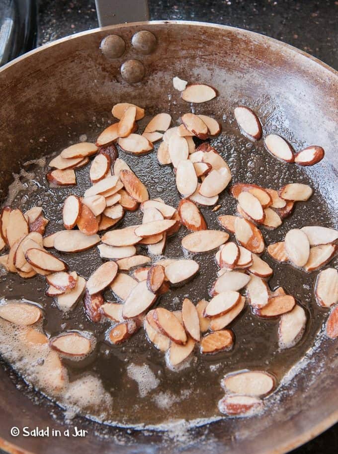 toasting almonds in a skillet.