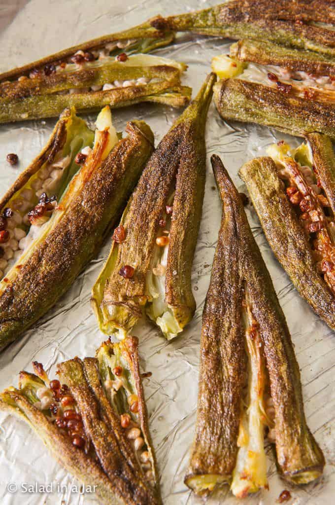 Grilled and Smashed okra on foil-lined baking sheet.