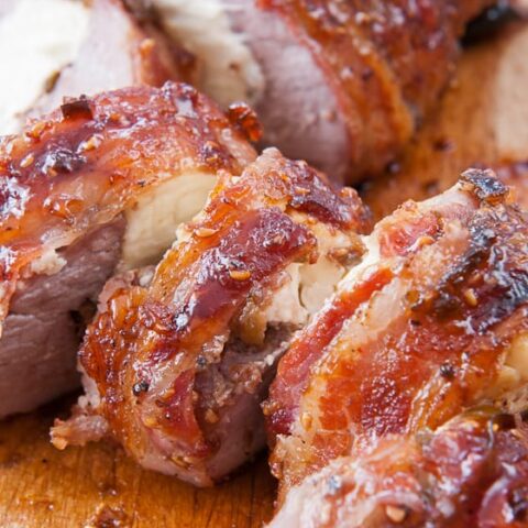 Bacon-Wrapped Stuffed Pork Tenderloin with Raspberry Chipotle Sauce