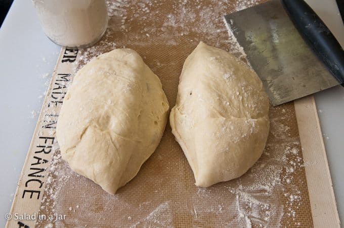 portioning the dough with a bench scraper.