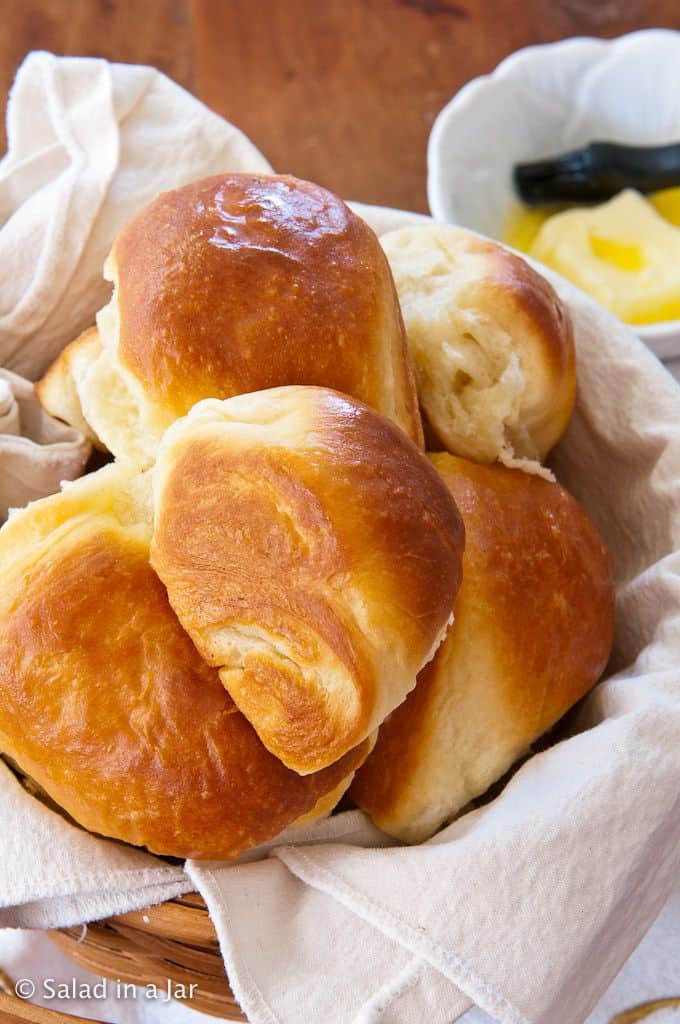 baked dinner rolls made with a bread machine in a basket and ready to eat.