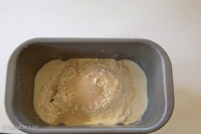 adding all the ingredients to the bread machine pan