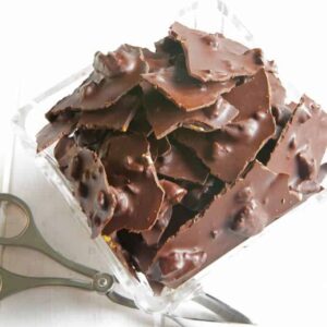 dark chocolate pieces with spicy pecans in a dish.