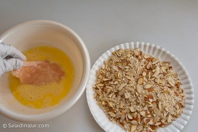 Dipping chicken tenders in egg wash.